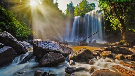 Serene Waterfall Amidst Lush Greenery Freshness of Nature's Beauty Awaits You wallpaper
