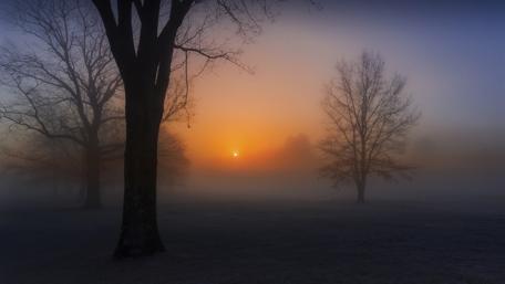Misty Sunset Over Foggy Landscape wallpaper