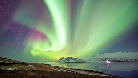 Majestic Northern Lights Over Serene Landscape wallpaper