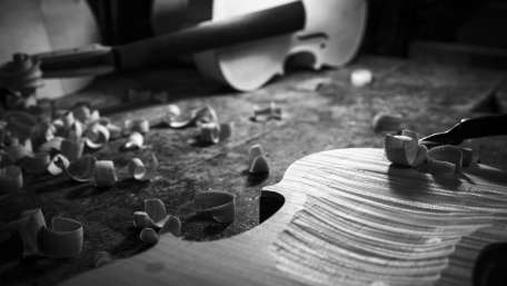 Crafting Melodies from Wood with Precision and Passion wallpaper