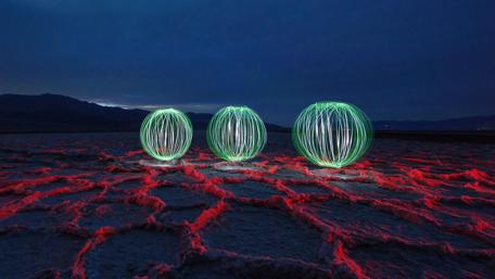 Mesmerizing Abstract Light Orbs in a Desert Landscape wallpaper