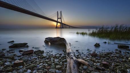 Serene Sunset Over Spectacular Bridge wallpaper