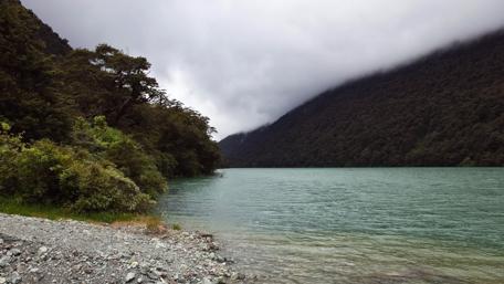 Serene Lake Amidst Majestic Mountains wallpaper