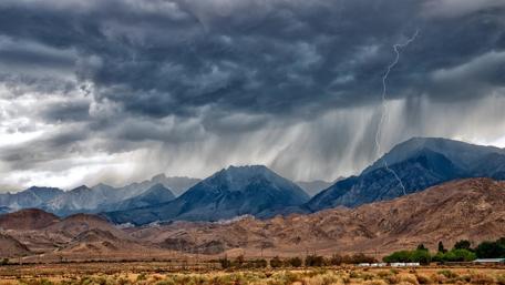 Stormy Mountains Under Dark Clouds and Lightning wallpaper