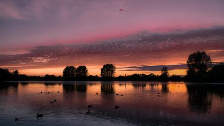 Serene Sunset Over Tranquil Lake Scene wallpaper