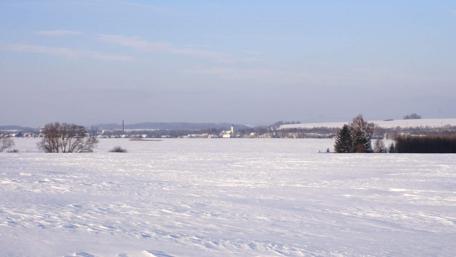 Snowy Landscape Under Clear Sky Amidst Tranquility wallpaper