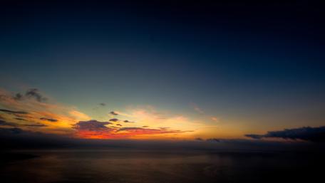 Serene Ocean Sunset Over Vibrant Sky wallpaper