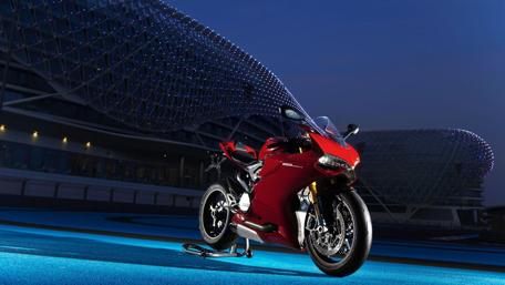 Sleek Red Superbike in Night Setting wallpaper