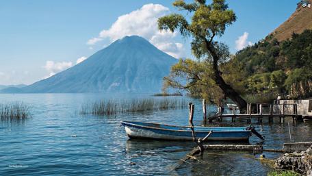 Serene Lake View with Boat and Mountain wallpaper
