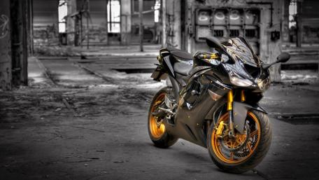 Sleek Motorcycle in Abandoned Warehouse wallpaper