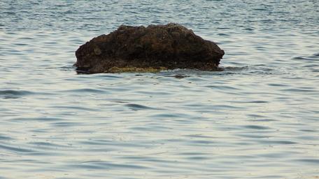Serene Rock in Calm Waters wallpaper
