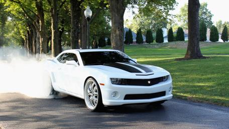 Sleek White Performance Car on a Scenic Drive wallpaper
