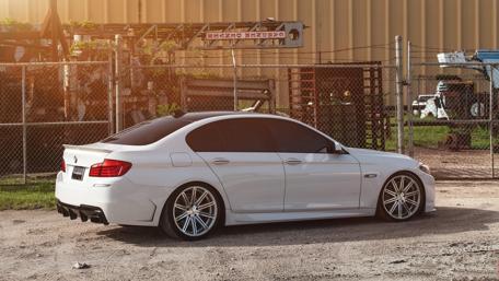 Sleek White Sedan in Urban Setting wallpaper