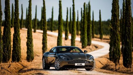 Sleek Luxury Car on Serene Pathway wallpaper