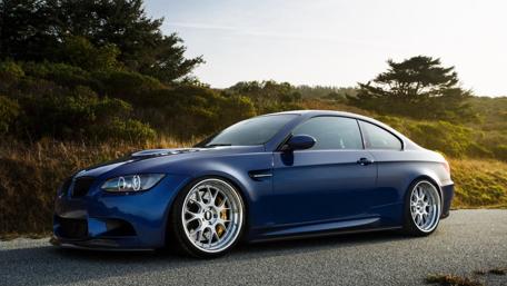 Sleek Blue Sports Car on a Scenic Road wallpaper