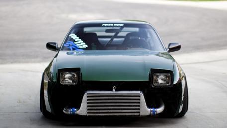 Sleek Green Car with Custom Modifications wallpaper