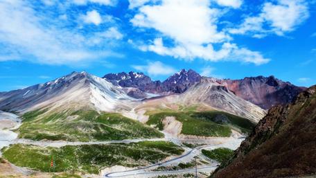 Majestic Mountain Range Under Blue Sky wallpaper