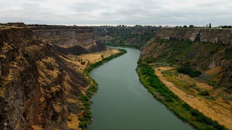 Majestic River Winding Through Rocky Canyons wallpaper