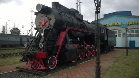 Vintage Steam Locomotive on Display in a Railway Yard wallpaper