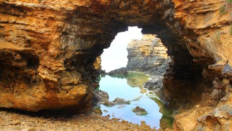 Serene Coastal Archway in Nature's Embrace wallpaper