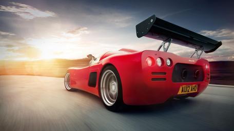 Red Dream Car Racing into the Sunset wallpaper