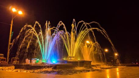 Breathtaking Night Fountain Display in Colorful Lights wallpaper