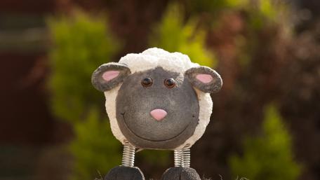 Cheerful Laughing Sheep Sculpture Wallpaper wallpaper