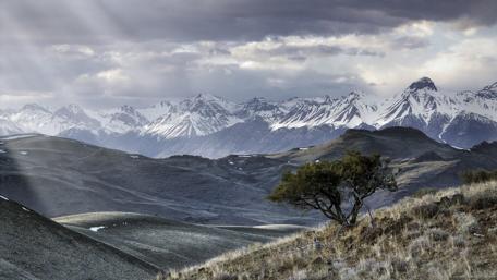 Sunlit Peaks and Serene Fields wallpaper