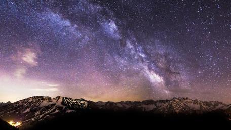 Majestic Milky Way Above Snowy Peaks wallpaper