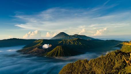 Majestic Mountain Range Beneath Blue Skies wallpaper