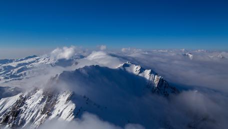 Majestic Mountain Peaks Above the Clouds wallpaper