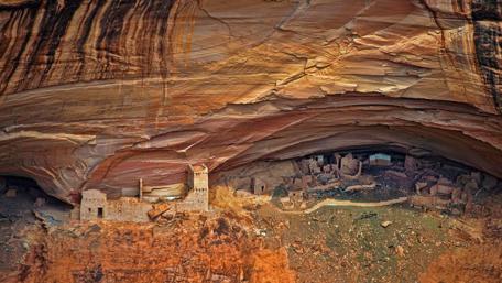 Ancient Ruins Nestled in Majestic Cliffs wallpaper