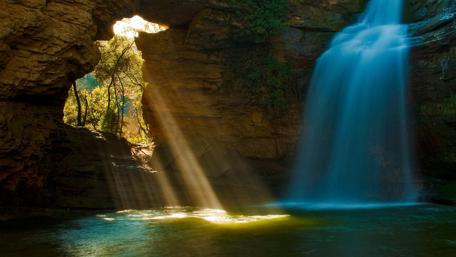 Serene Waterfall Surrounded by Nature's Beauty wallpaper