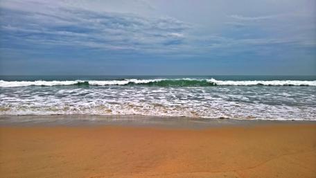 Tranquil Waves of Maikhao Beach in Thailand wallpaper
