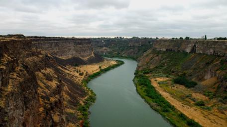Serene River Winding Through Majestic Canyons wallpaper