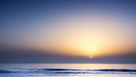 Serene Sunset Over Tranquil Sea Waters wallpaper