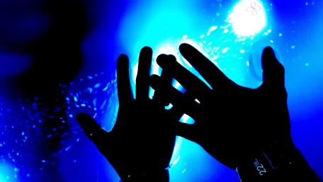 Hands Embracing a Dreamy Blue Glow wallpaper