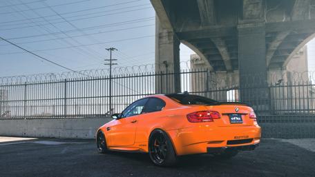 Orange BMW Elegance Under Urban Bridge wallpaper