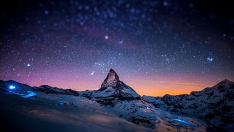 Starry Night Over Mountain Peaks in Purple Hue wallpaper