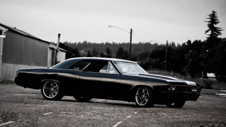 Sleek Black Car in Urban Setting wallpaper