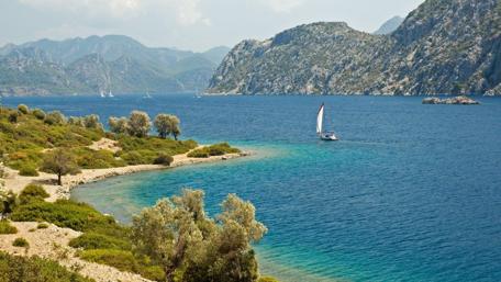 Serene Coastal Escape with Sailing Boat and Mountains wallpaper