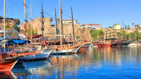 Serene River Scene with Boats and City Life wallpaper