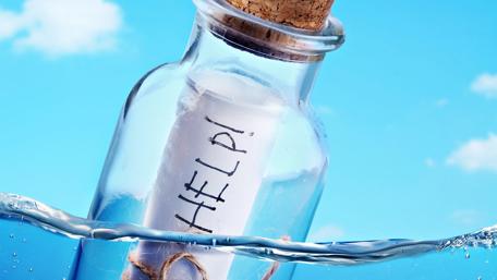 Title: Message in a Bottle Floating on Blue Waters wallpaper
