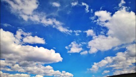 Bright Blue Sky with Fluffy Clouds wallpaper