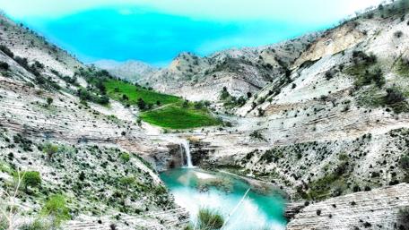 Majestic Waterfall in Serene Landscape wallpaper
