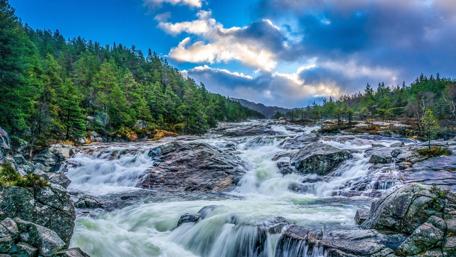 Waterfalls Amidst a Serene Rocky Landscape wallpaper