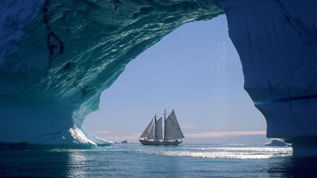 Majestic Sailboat in Icy Archway wallpaper