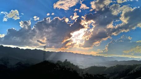 Serene Mountain View Under Dramatic Clouds wallpaper