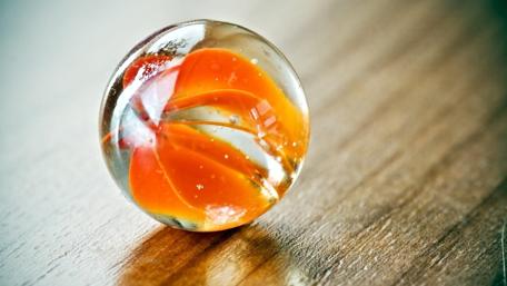 Glass Sphere on Wooden Surface wallpaper