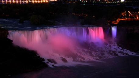 Majestic Waterfall Illuminated at Night wallpaper